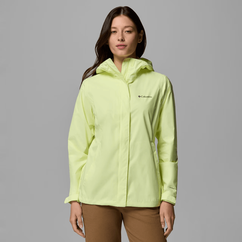 Load image into Gallery viewer, Woman wearing a light green Columbia jacket on a gray background