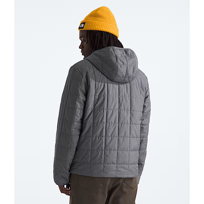 Load image into Gallery viewer, Person wearing a gray quilted jacket and yellow beanie on a light gray background