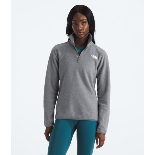 Woman wearing a gray pullover with a logo on a white background