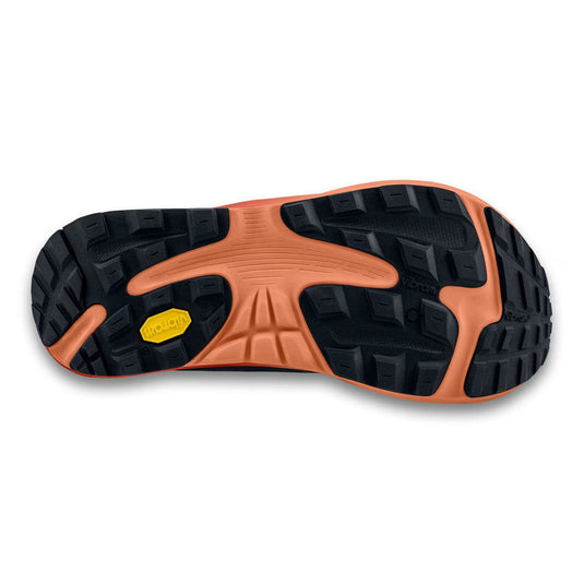Close-up of a shoe sole with orange and black tread pattern on a white background