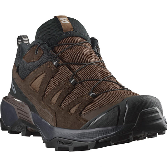 Brown hiking shoe with black sole on a white background
