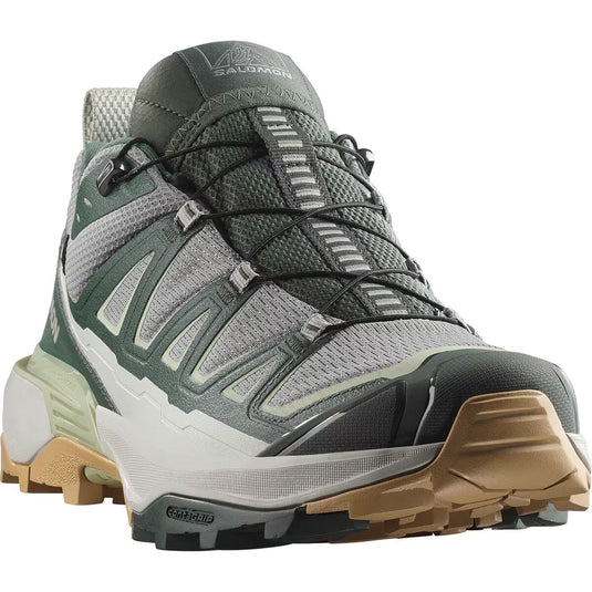 Gray hiking boot with brown sole on a white background