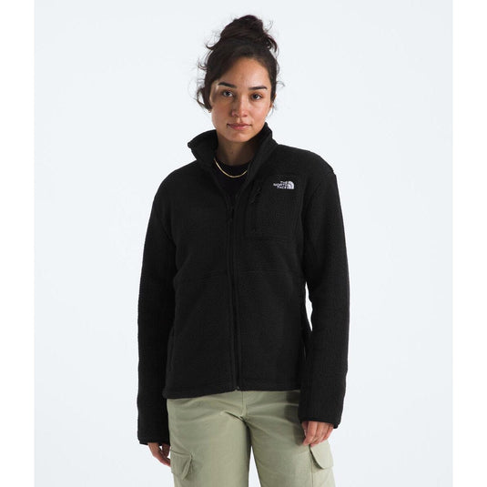 Woman wearing a black jacket with a brand logo on a white background