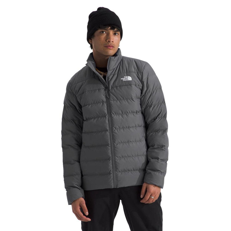 Load image into Gallery viewer, Person wearing a gray puffer jacket with a brand logo on a white background
