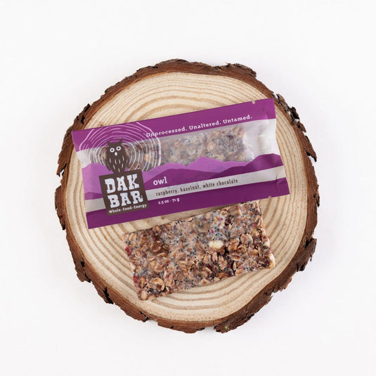 Dak Bar owl treat on a wooden log with a purple label