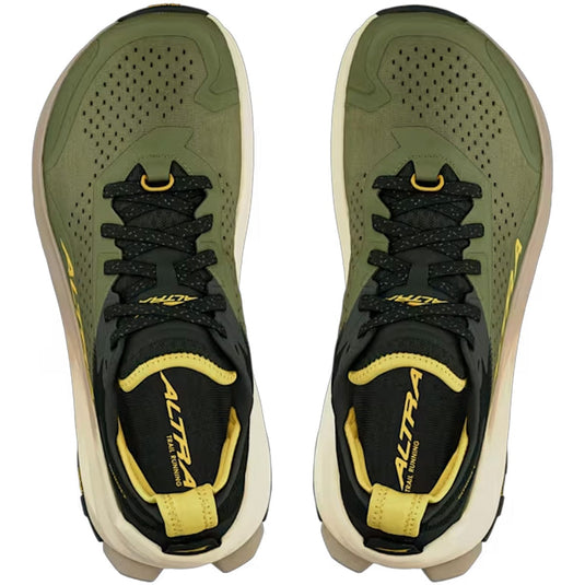 Pair of green and black sneakers with yellow accents on a white background