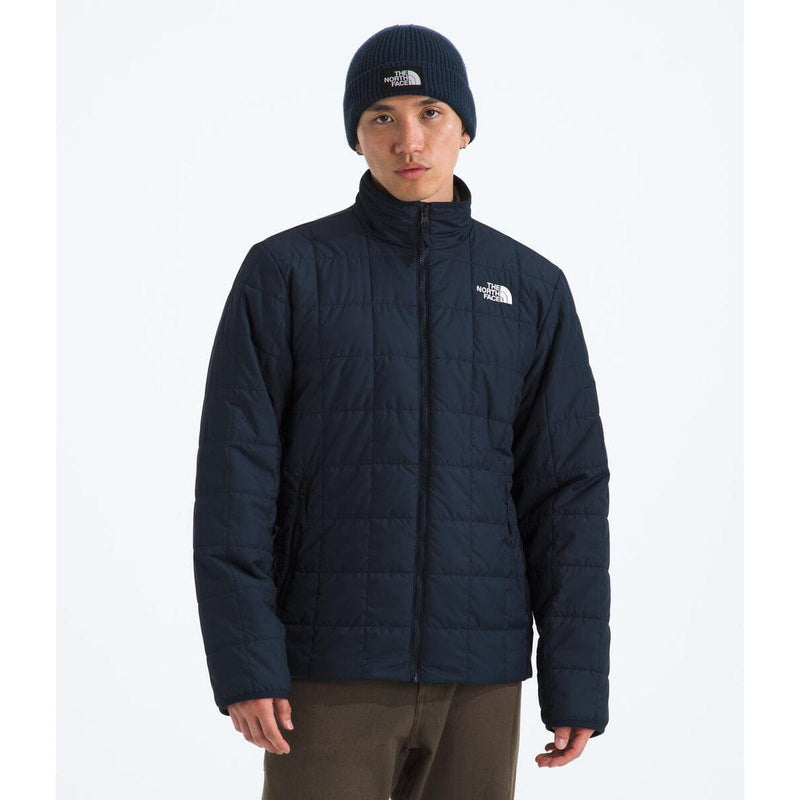 Load image into Gallery viewer, Person wearing a navy blue jacket and beanie with a brand logo on a white background