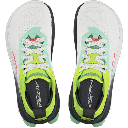 Pair of white running shoes with green and black accents on a white background