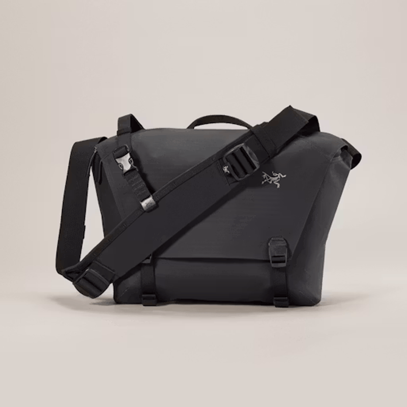 Load image into Gallery viewer, Black shoulder bag with a visible brand logo on a beige background
