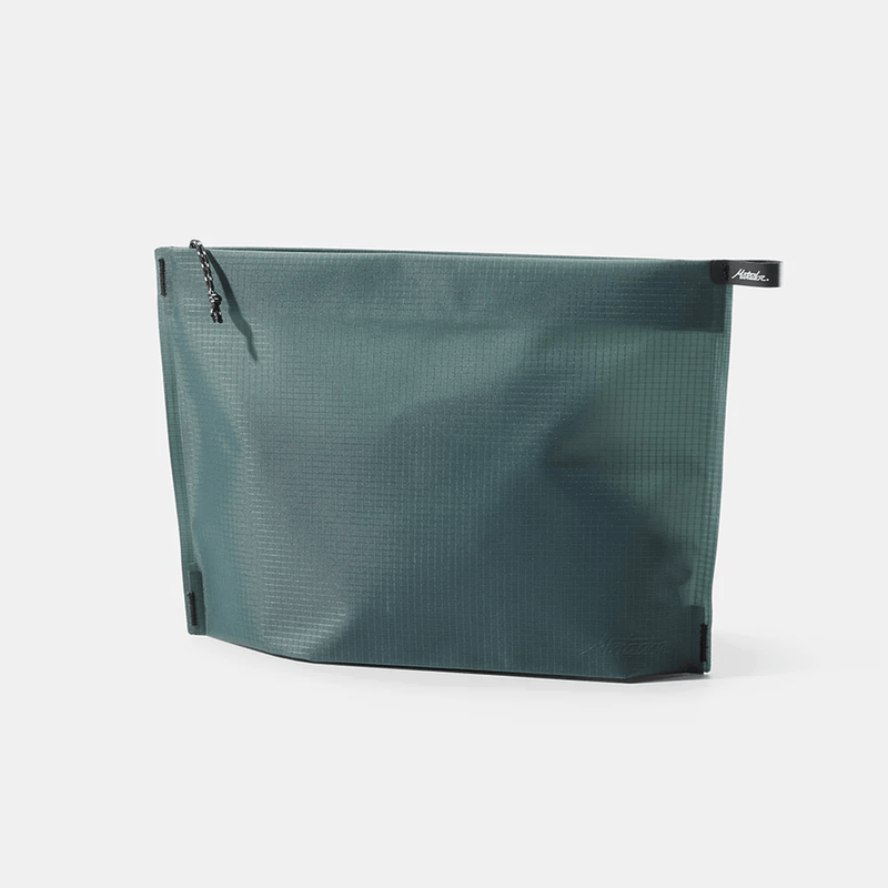 Load image into Gallery viewer, Green toiletry bag with a textured surface on a white background
