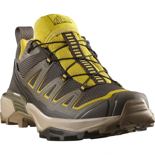 Yellow and gray hiking shoe with Salomon branding on a white background