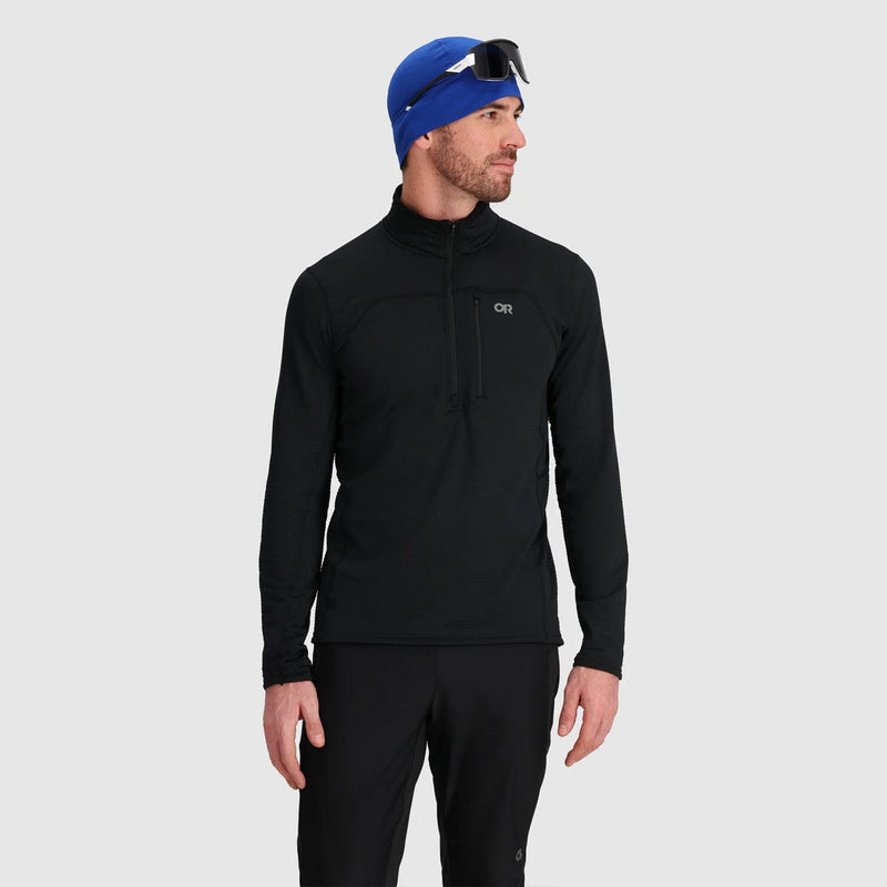 Load image into Gallery viewer, Man wearing a black long-sleeve athletic shirt and blue beanie on a light gray background