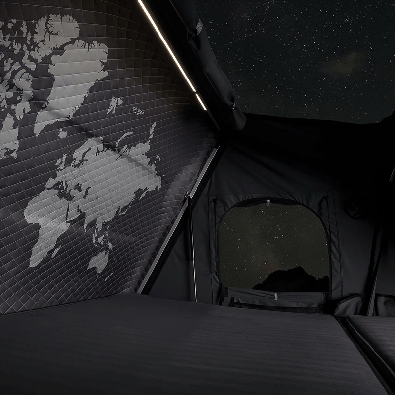 Load image into Gallery viewer, Tent interior with world map on wall and starry night view