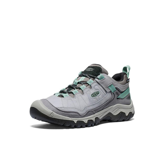 Gray and green hiking shoe on a white background
