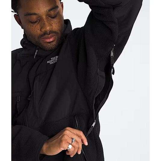 Person wearing a black jacket with The North Face logo on a white background