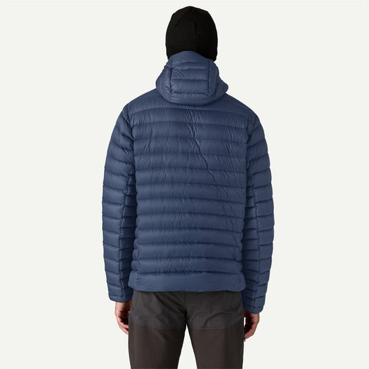 Person wearing a blue puffer jacket on a white background