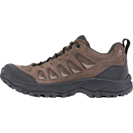 Brown hiking shoe with black sole on a white background