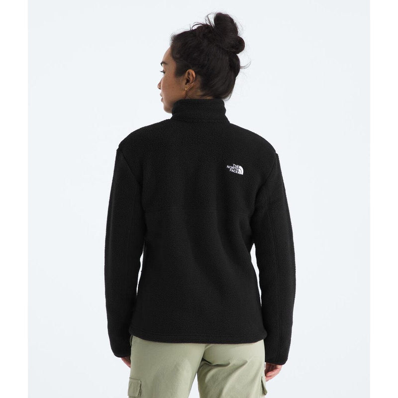 Load image into Gallery viewer, Person wearing a black fleece jacket with a logo on the back, standing against a white background