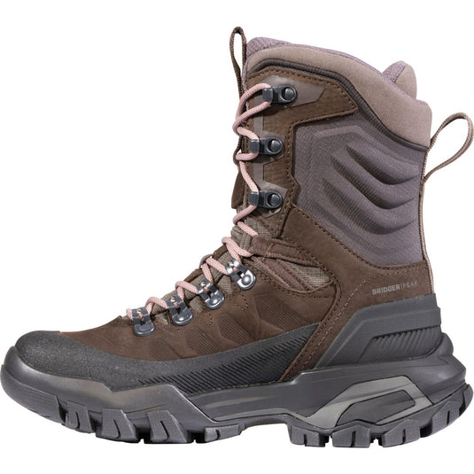 Brown and gray hiking boot with pink laces on a white background