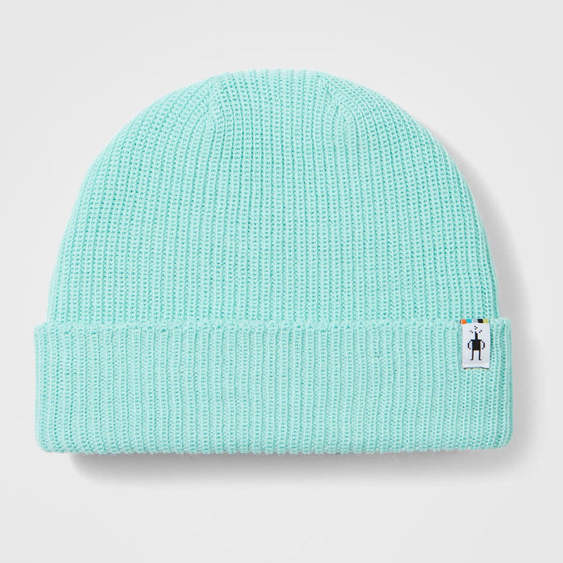 Load image into Gallery viewer, Light blue knit beanie with a small label on a light gray background