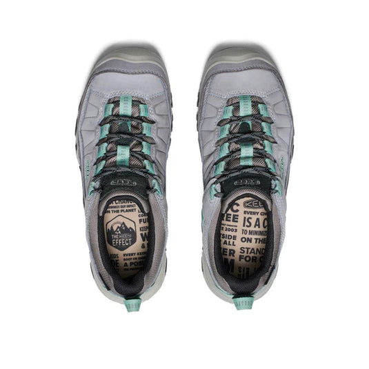 Pair of gray and teal hiking shoes on a white background
