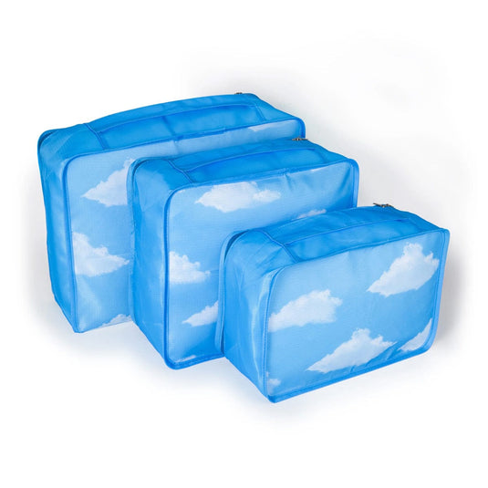 Set of three blue packing cubes with cloud pattern on a white background