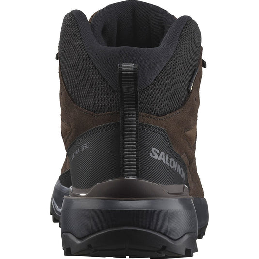 Back view of a brown and black hiking boot with 'Salomon' branding on a white background
