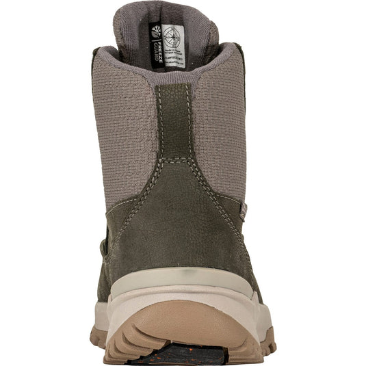 Back view of a green hiking boot with brand label on a white background
