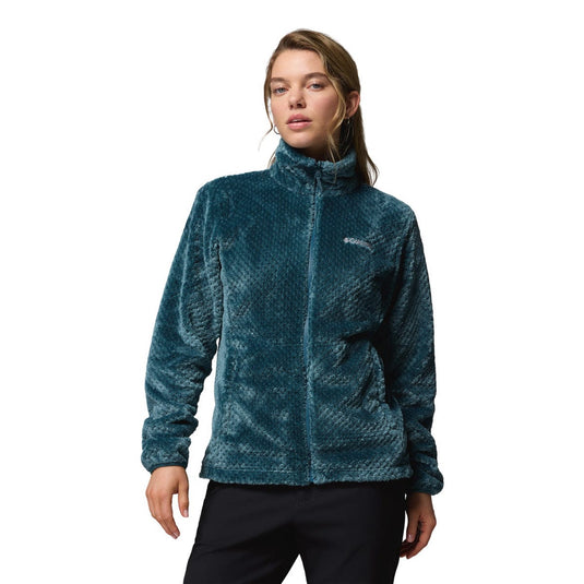 Woman wearing a textured teal jacket on a white background