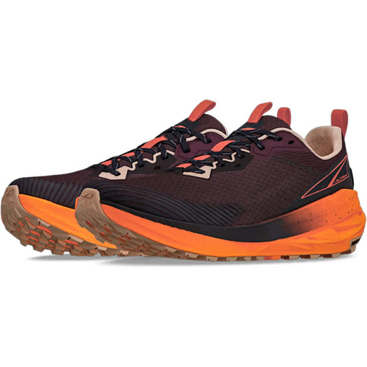 Pair of trail running shoes with orange and black design on a white background