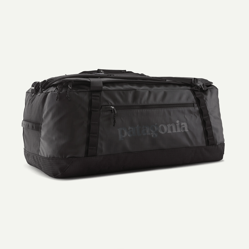 Load image into Gallery viewer, Black duffel bag with Patagonia logo on a light gray background