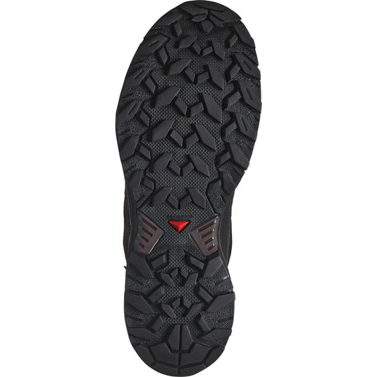 Close-up of a black hiking boot sole with a red logo on a white background