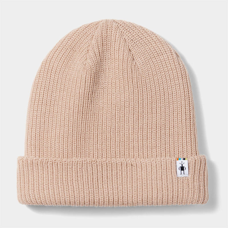 Load image into Gallery viewer, Beige knit beanie with a small label on a light gray background