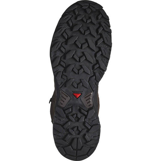Close-up of a black hiking boot sole with a red logo on a white background