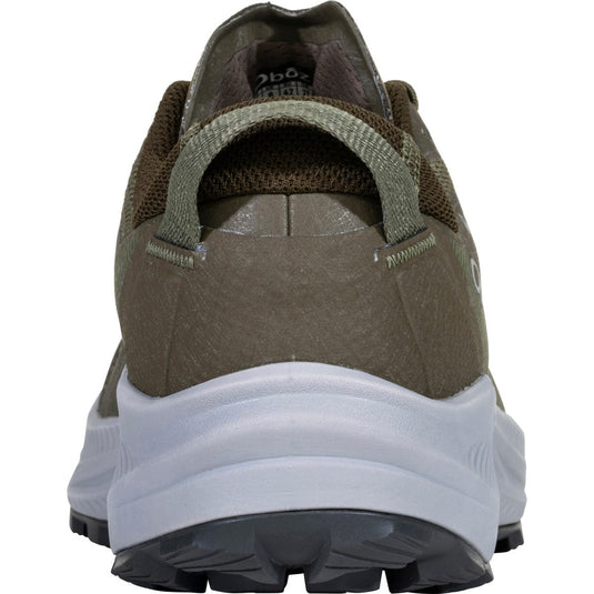 Green hiking shoe with white sole on a white background