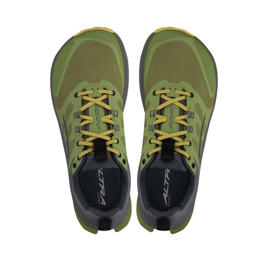 Green and black running shoes with yellow accents on a white background