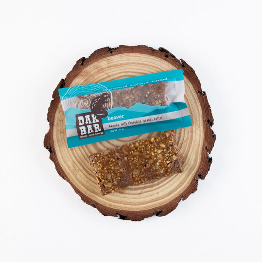 Dak Bar snack bar on a wooden log with a visible label