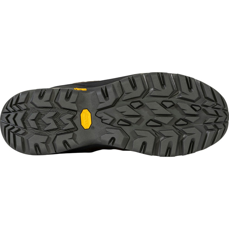 Load image into Gallery viewer, Close-up of a black shoe sole with a yellow label on a white background