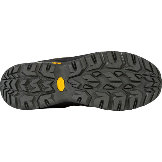Close-up of a black shoe sole with a yellow label on a white background