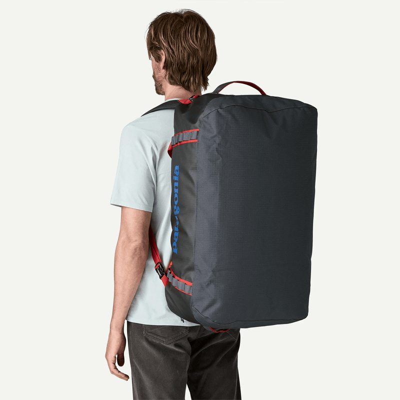 Load image into Gallery viewer, Person wearing a large black backpack on a white background