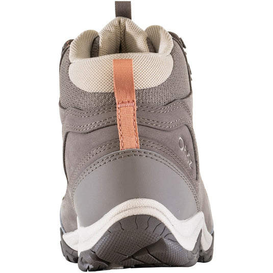 Gray hiking boot with a white sole on a white background