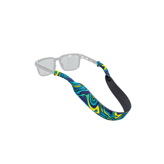 A pair of clear-framed sunglasses with a colorful patterned fabric strap featuring swirls of blue, yellow, and green, and a black foam loop at the end, shown on a plain white background.