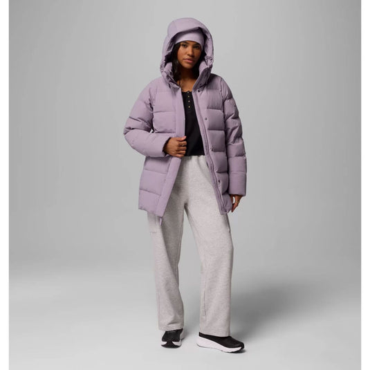 Person wearing a light purple puffer coat on a gray background
