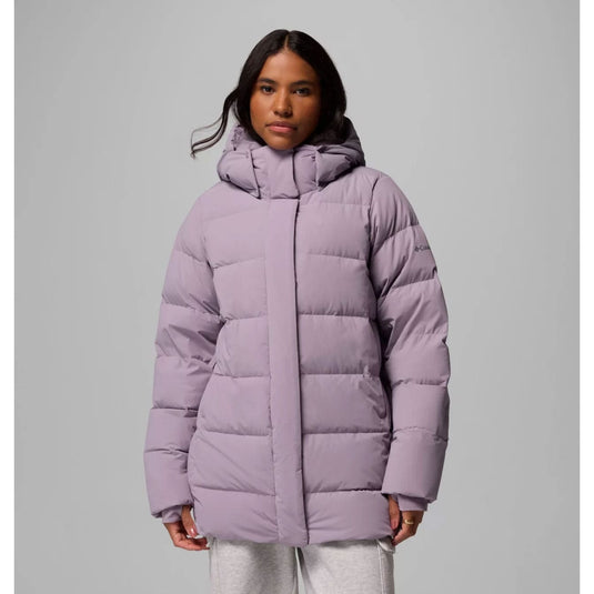 Person wearing a light purple puffer jacket on a gray background
