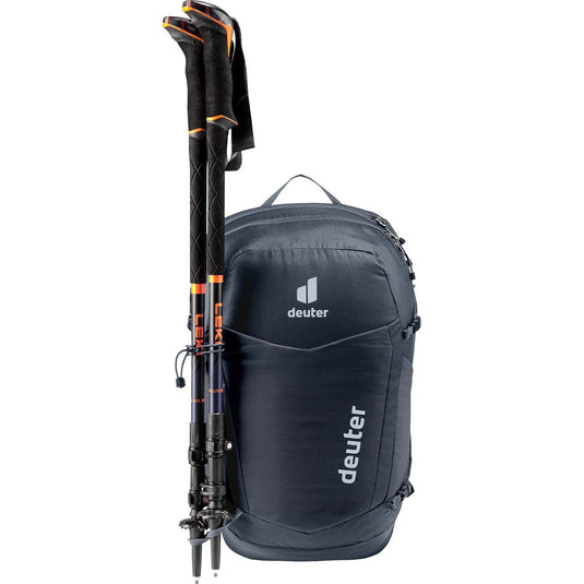 Black backpack with ski poles attached on a white background
