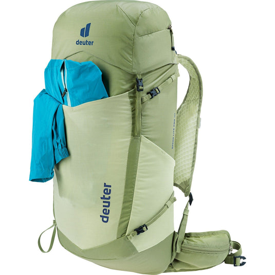 Green Deuter backpack with a blue garment on a white background