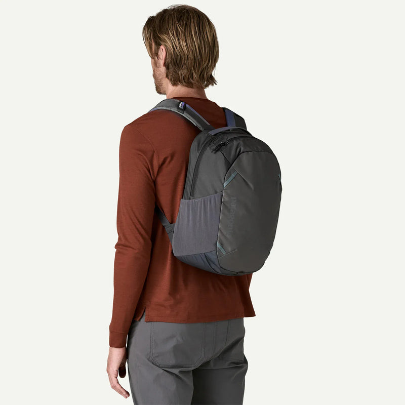 Load image into Gallery viewer, Person wearing a gray patagonia backpack on a white background
