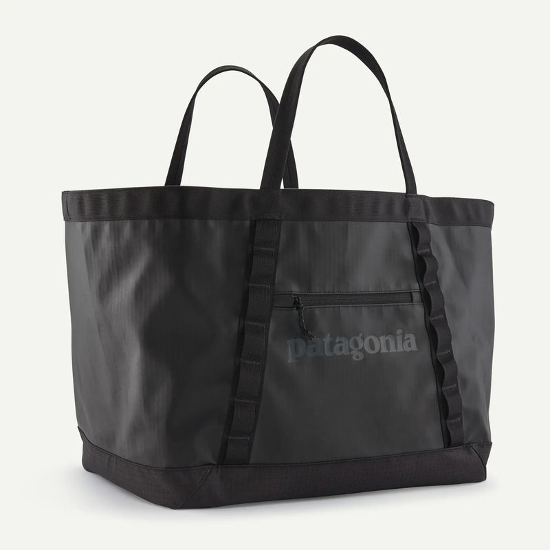 Load image into Gallery viewer, Black tote bag with Patagonia logo on a white background
