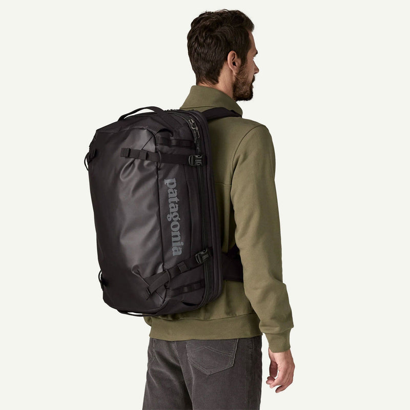 Load image into Gallery viewer, Man wearing a Patagonia backpack on a white background
