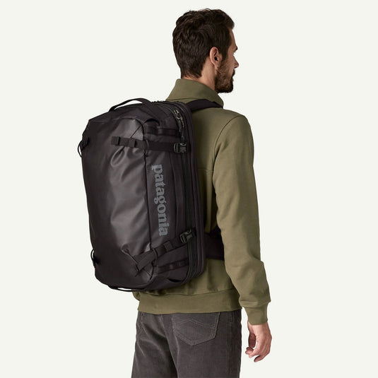 Man wearing a Patagonia backpack on a white background